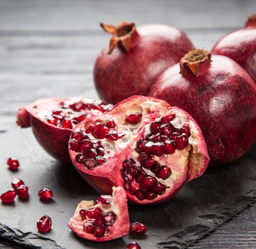 Red,Juice,Pomegranate,On,Dark,Background